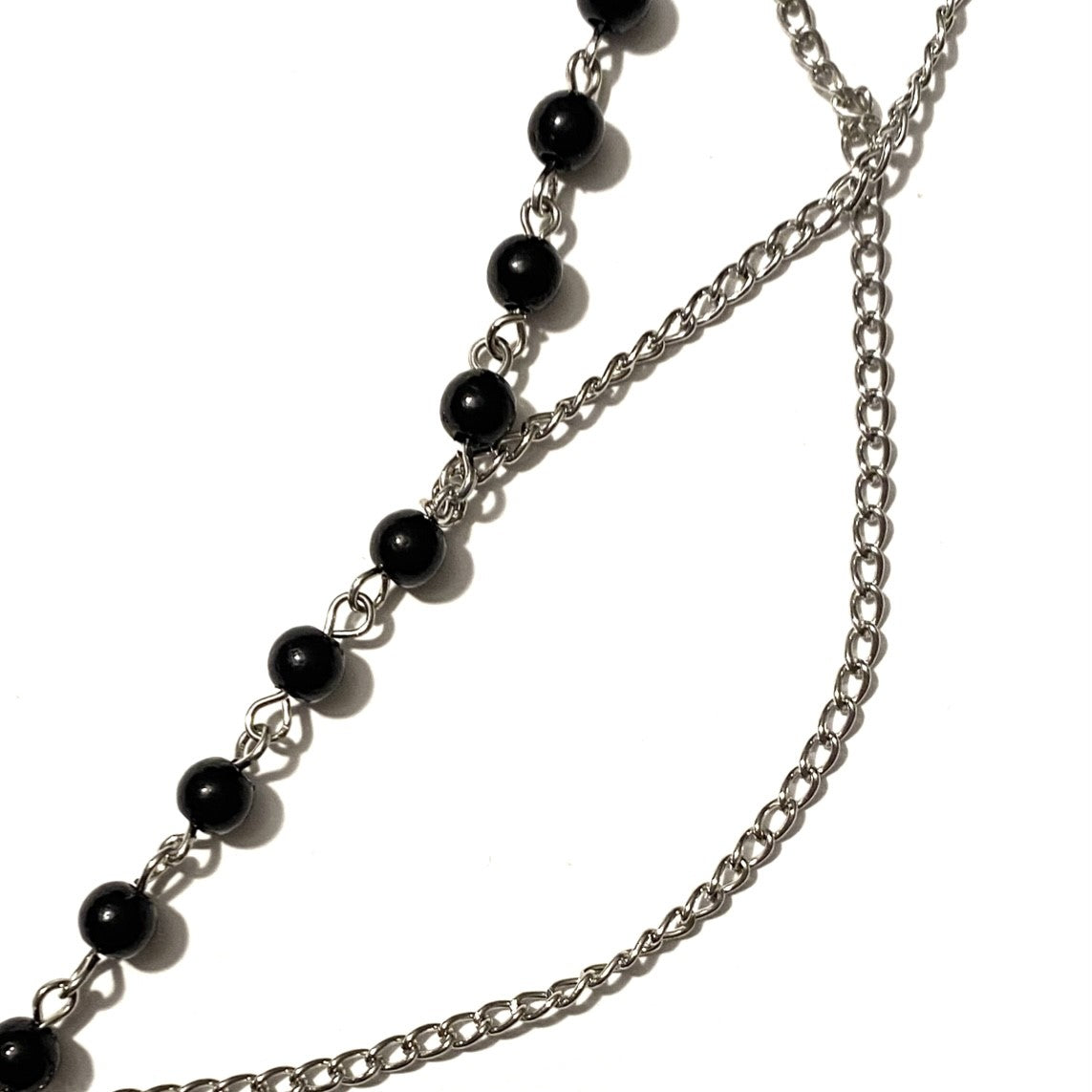 Necklace with black beads and cross