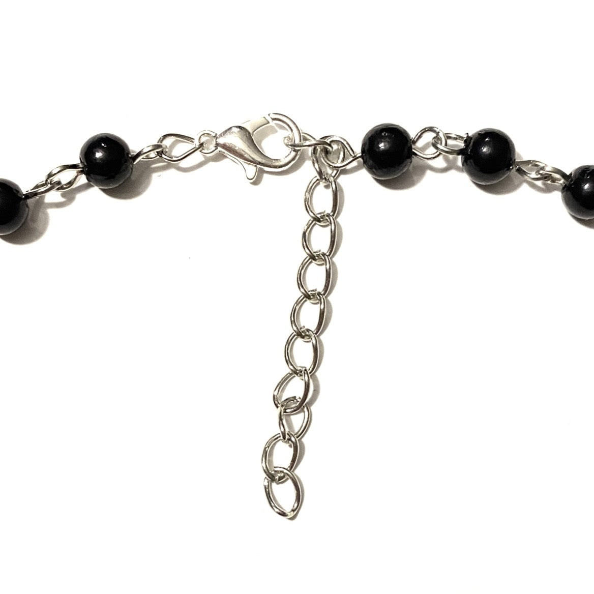 Necklace with black beads and cross